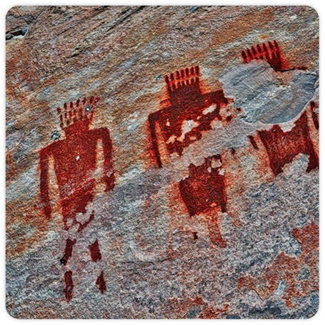 Photograph of red pictographs of human figures on a sandstone wall.